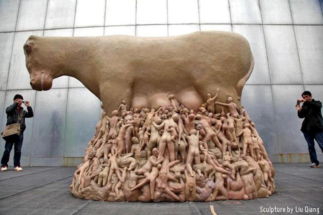 A telling sculpture by Liu Qiang of a cow with hundreds of humans suckling beneath her